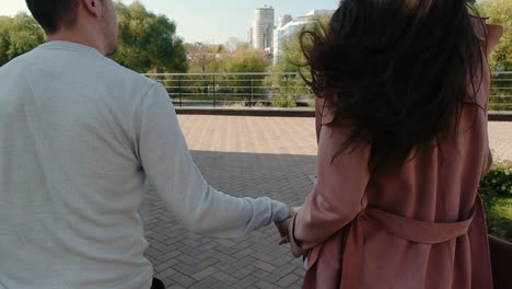 couple walking and running in the city park