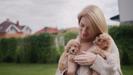 portrait of an attractive woman with two maltipu puppies