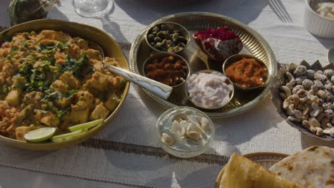 an array of traditional indian dishes laid out on a table