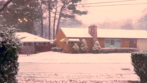 warm clip of snow falling on a small town on the shore of lake michigan