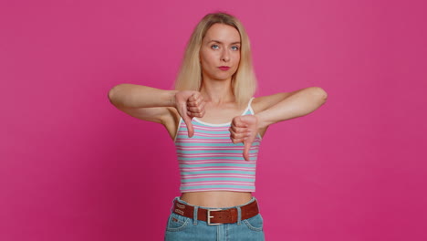 upset woman girl showing thumbs down gesture disapproval dissatisfied dislike negative feedback