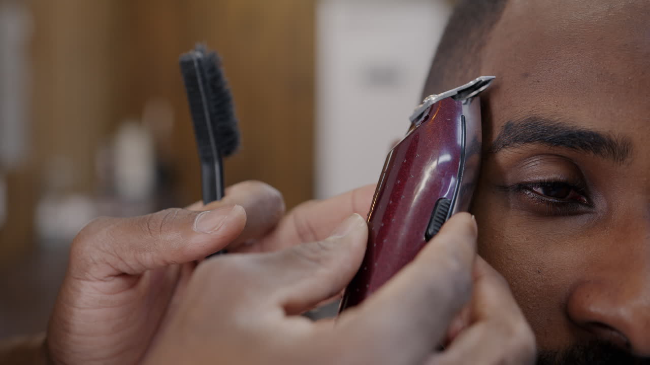 Close-up of a man getting a haircut at the barber shop