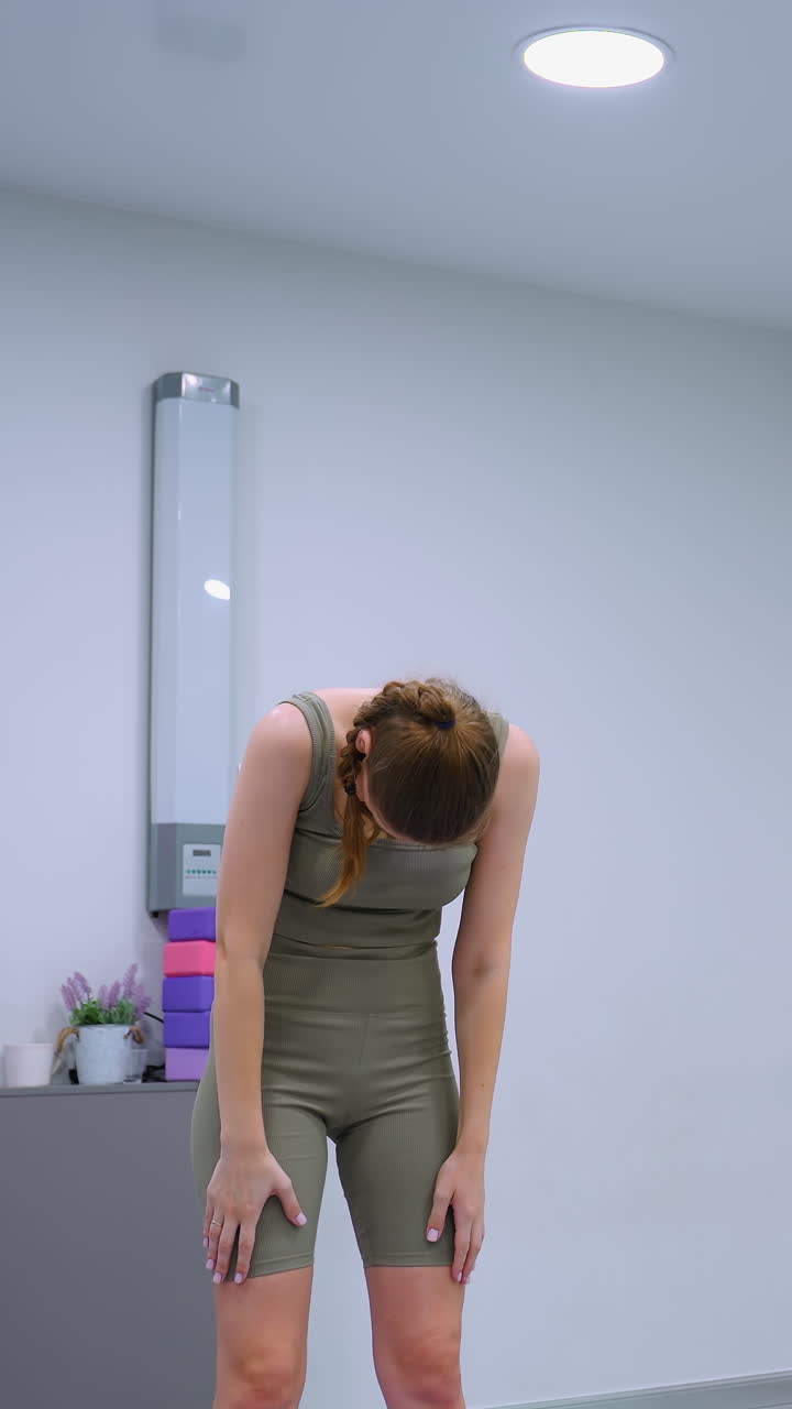 Sessione di yoga in corso con il direttore della palestra che guida, mostrando i partecipanti in pose coordinate sullo sfondo di palloncini verdi e varie attrezzature da palestra.