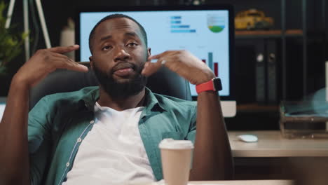 Closeup-tired-african-american-businessman-relaxing-in-hipster-office