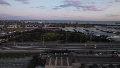 cars travelling on a highway through an industrial district, melbourne