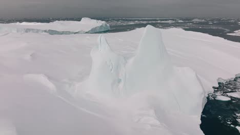 drone over sea and ice of ilulissat icefjord