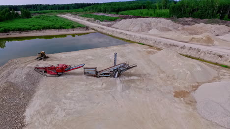 Open-pit-quarry-for-gravel-and-sand-construction-materials---orbiting-aerial-view