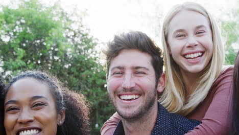 portrait of group of multi-cultural friends enjoying outdoor summer garden party