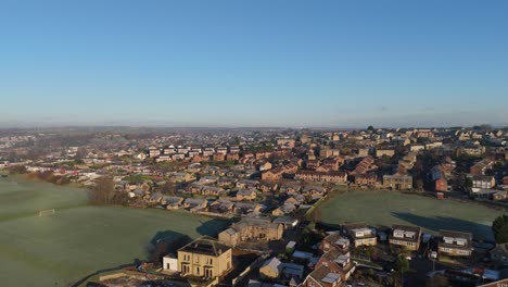 drone's-eye winter view captures dewsbury moore council estate's typical uk urban council-owned housing development with red-brick terraced homes and the industrial yorkshire