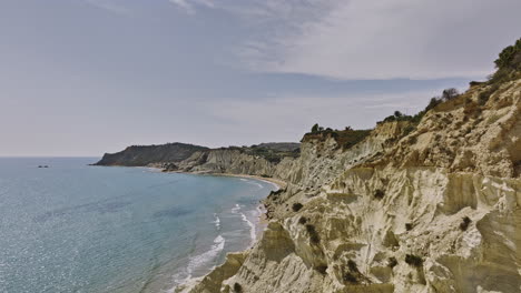 scala dei turchi italy aerial v4 cinematic tracking reveal shot capturing azure coastal landscape of white marl cliffs, unique rock formations in mediterranean sea - shot with mavic 3 cine - june 2023