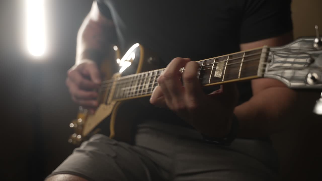 Close Up Of Guitar Player Picking On Electric Guitar