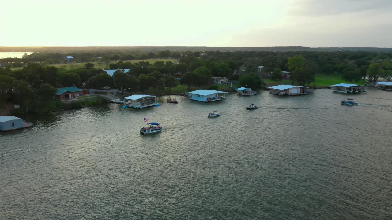 Boats on a lake with boathouses.  Summer vacation fun.  Boat Parade