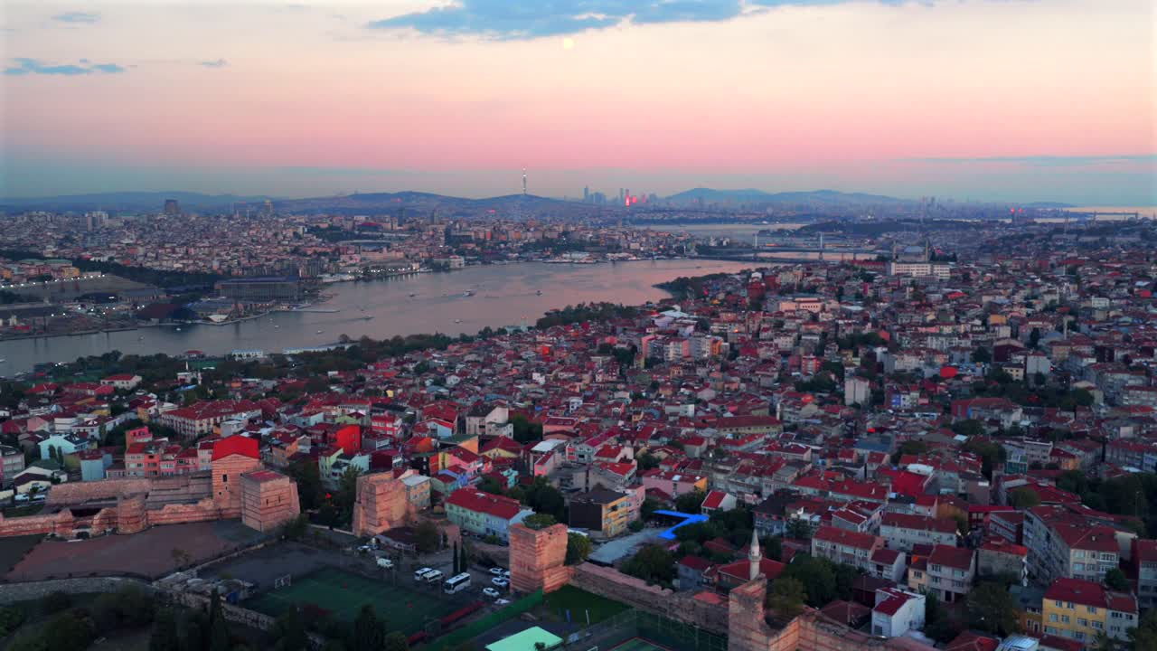 Istanbul Turkey Türkiye aerial drone Bosphorus Strait ferry boats harbor view sunset golden hour pink sky afterglow cityscape buildings panoramic landscape skyscrapers mosque forward upwards