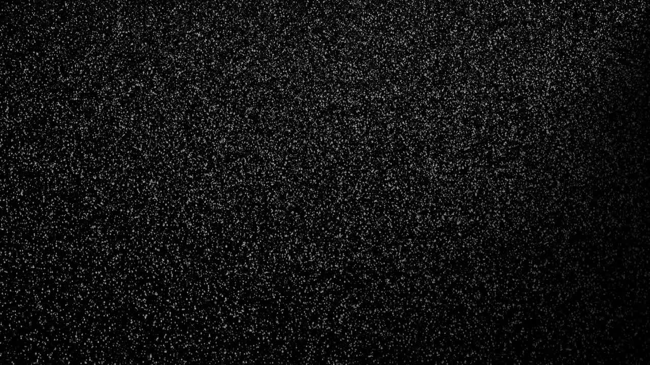 la lluvia fuerte o la nieve se parecen en la noche oscura con la luz que brilla sobre la partícula de lluvia o nieve.