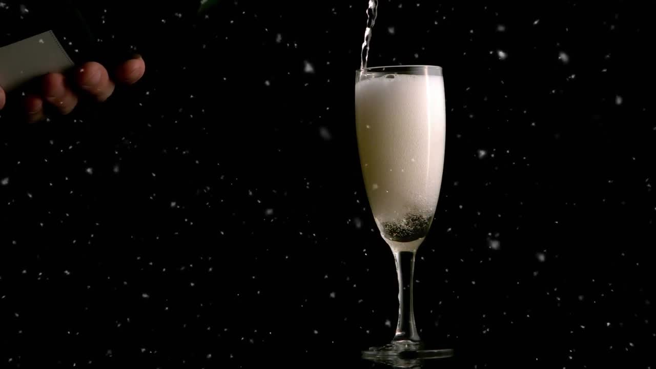 Animación de puntos blancos cayendo sobre una copa de champán