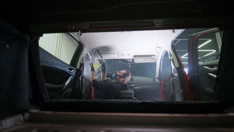 professional car cleaning. сar wash. interior detailing. dry clean and detail a car interior. deep seats cleaning. wiping foam in car wash. cleaning the car panel from dust. a vacuum cleaner