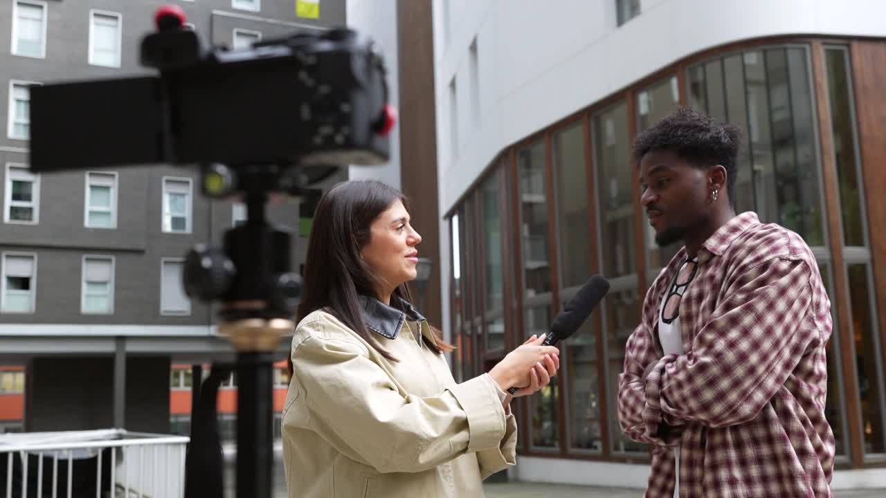 Young Woman Interviews Man for Video Content Outdoors