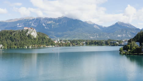 picturesque view of a resort town with the julian alps in background along lake bled in slovenia