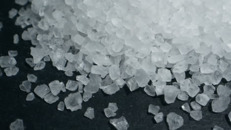 white salt close-up macro. spice for food. sea salt for bath. man hand srewing salt on table . high quality 4k footage