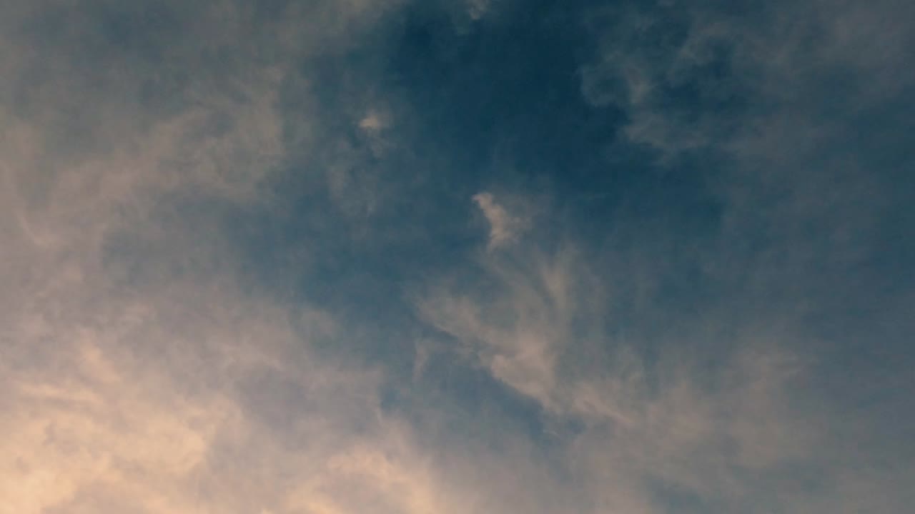 Under an umbrella of fluffy morning clouds and city views against a blue sky.