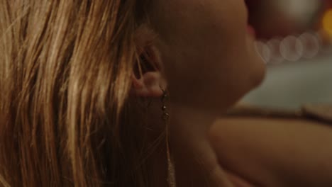 beautiful macro of an attractive woman joyfully playing with her hair in slow motion