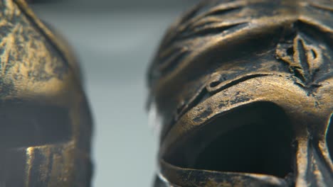 close-up view of ancient bronze helmets or masks