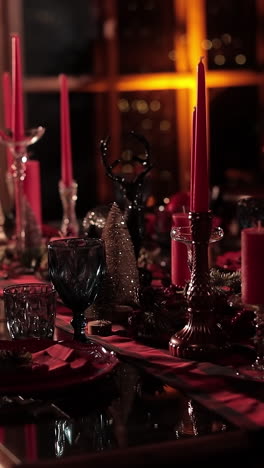 dining table prepared for christmas dinner. festive table decorated with candles on christmas tree background with lights. festive serving. vertical video
