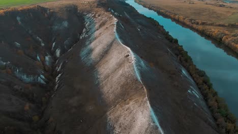 aerial view of a river valley with hills and cliffs