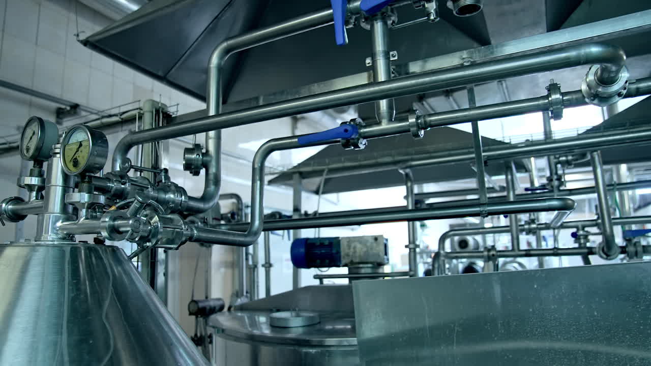 Steel shiny tubes with sensors and valves interlinking with each other. Complicated equipment for dairy food production.