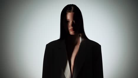 woman emerges from shadow into light