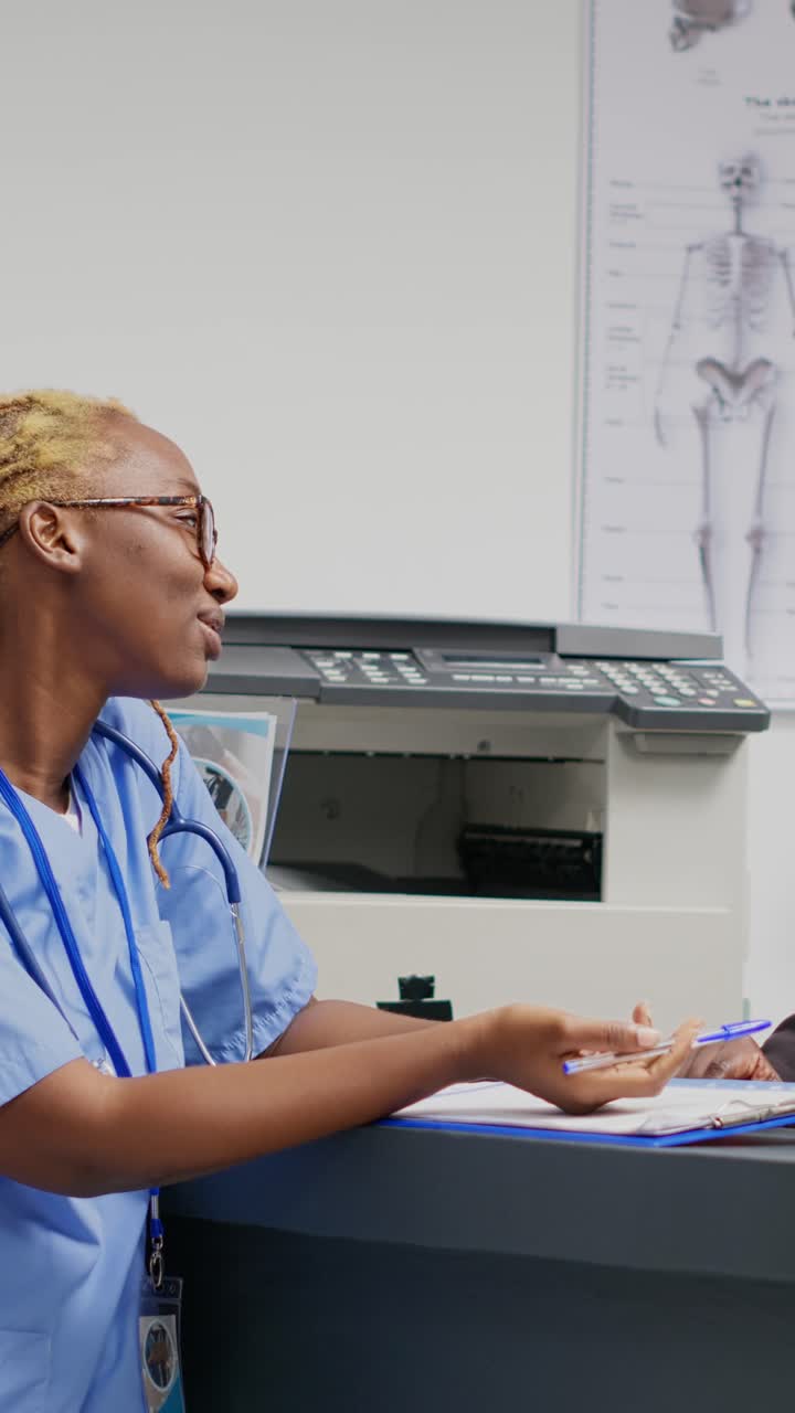 Vertical video: African american women looking at report papers