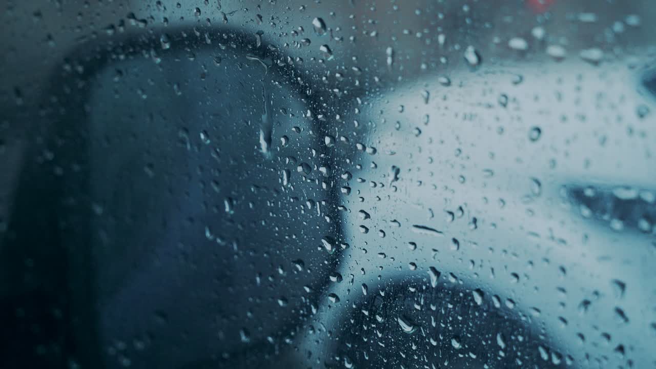Windscreen at the time of the rain. Mirror of car
