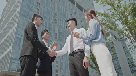 smart business men make shake hands when meeting in outdoors office, agree to a deal or say hello