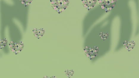animación de un patrón floral con corazones cayendo sobre un fondo verde