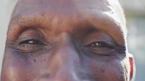 portrait of close up of eyes of happy unaltered senior african american man, in slow motion