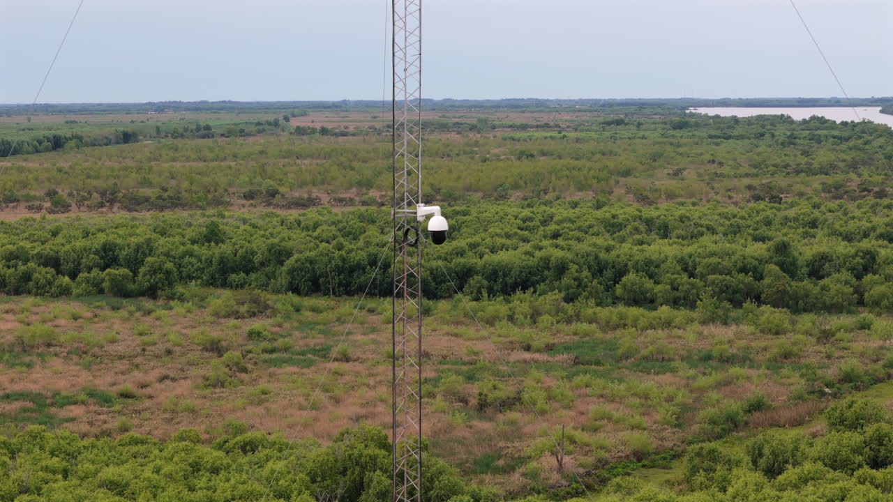 Aerial reveals surveillance system is a technology that monitors, camera filming a rural forest environment
