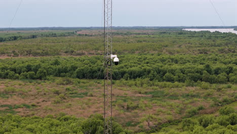 aerial reveals surveillance system is a technology that monitors, camera filming a rural forest environment