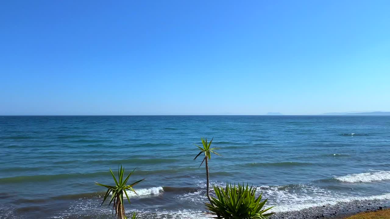 Serene Coastal View: Ocean, Beach, and Summer Sky