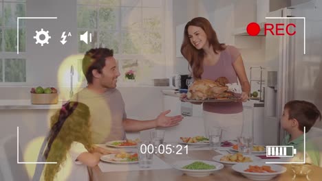 animation of digital interface over caucasian family eating dinner