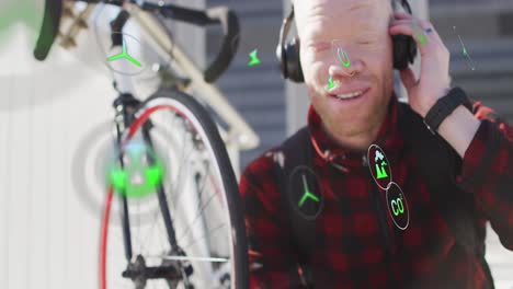 Animation-of-icons,-albino-african-american-man-listening-to-music-wearing-headphones-with-bicycle