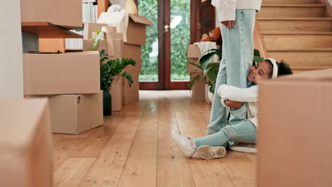 kid holding the leg of her dad at their home