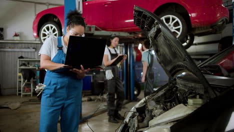 women working on a garage