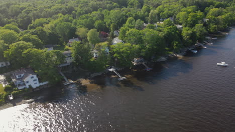 aerial view of a lake shoreline with houses and a boat