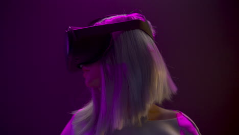 excited woman experiencing headset videogame neon background. technology concept