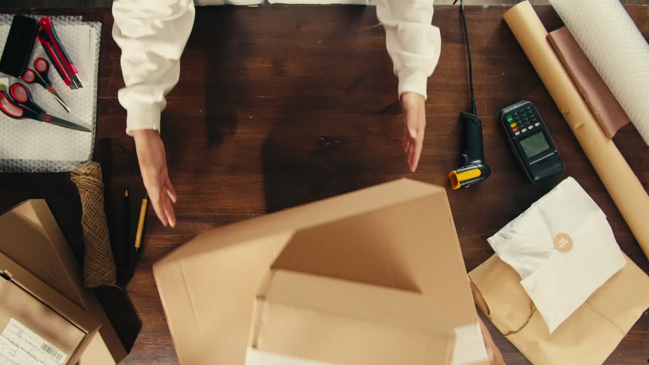 E-commerce storage shop, woman packing goods and clothes for second hand delivery market, dedicated Packaging and Shipping Workspace with Supplies and Technology for efficiency, online sales.