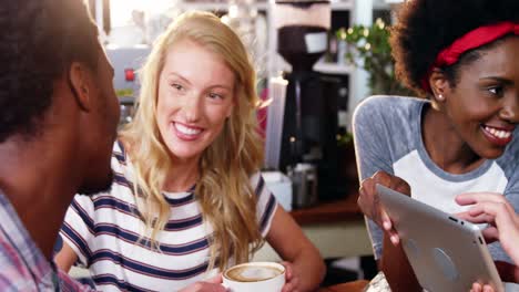 friends interacting while having coffee