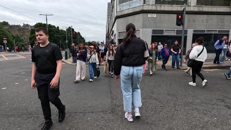 people crossing a street during edinburgh fringe festival