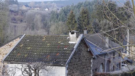 Belgian-architectural-farm-houses-with-the-hills-in-the-background-in-southern,-Belgium