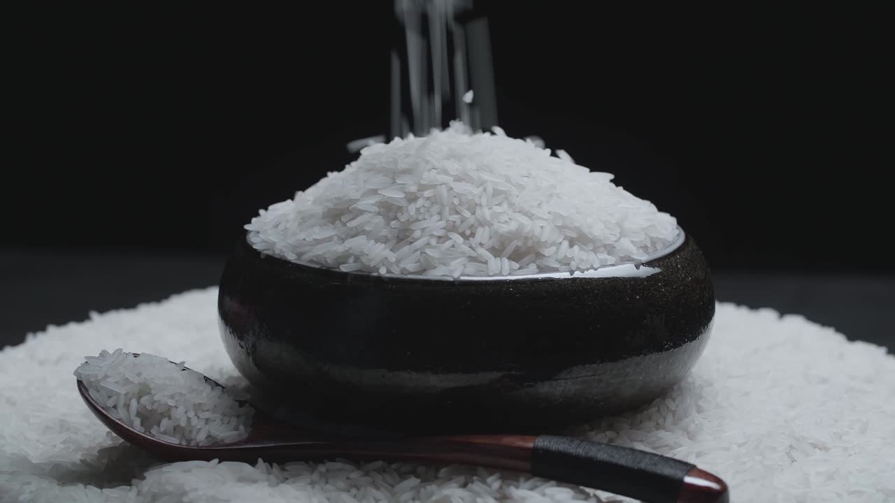 White Rice Grain Falling Into A Unique Bowl Rotating