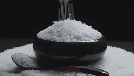 white rice grain falling into a unique bowl rotating
